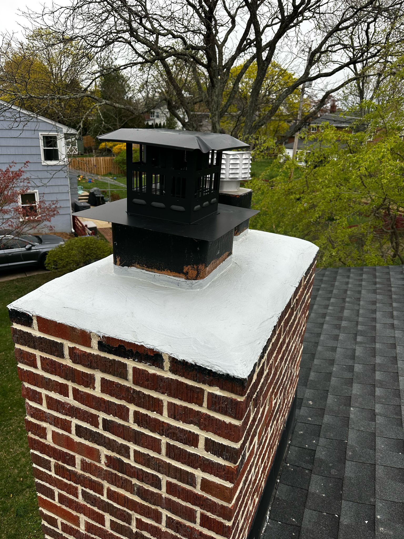 Red brick chimney cap with beige top - outdoor repair work